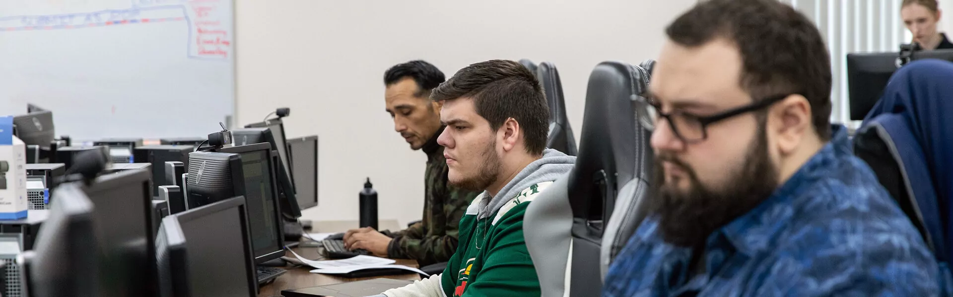 Students type at computers in a computer lab