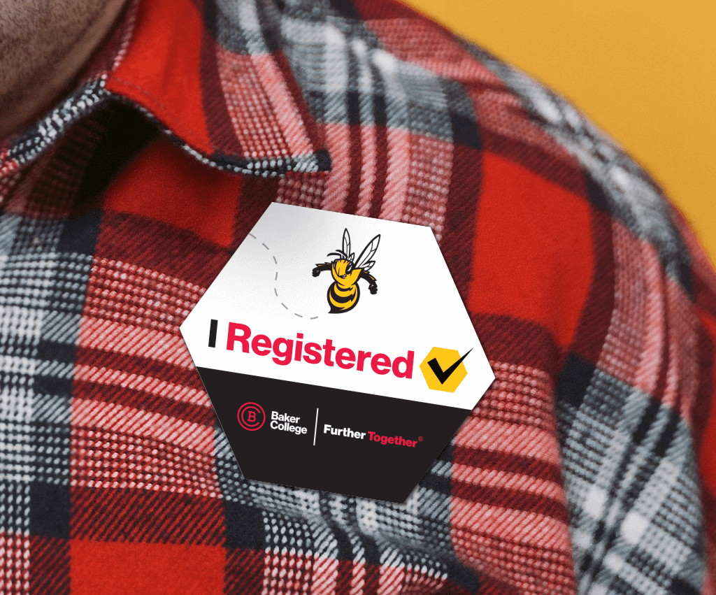 A close-up photo of an "I Registered" button featuring Scout the Bee and the Baker College logo and "Further Together" word mark.