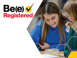 A student smiles while checking a class schedule next to text that says Be(e) Registered with a checkmark.