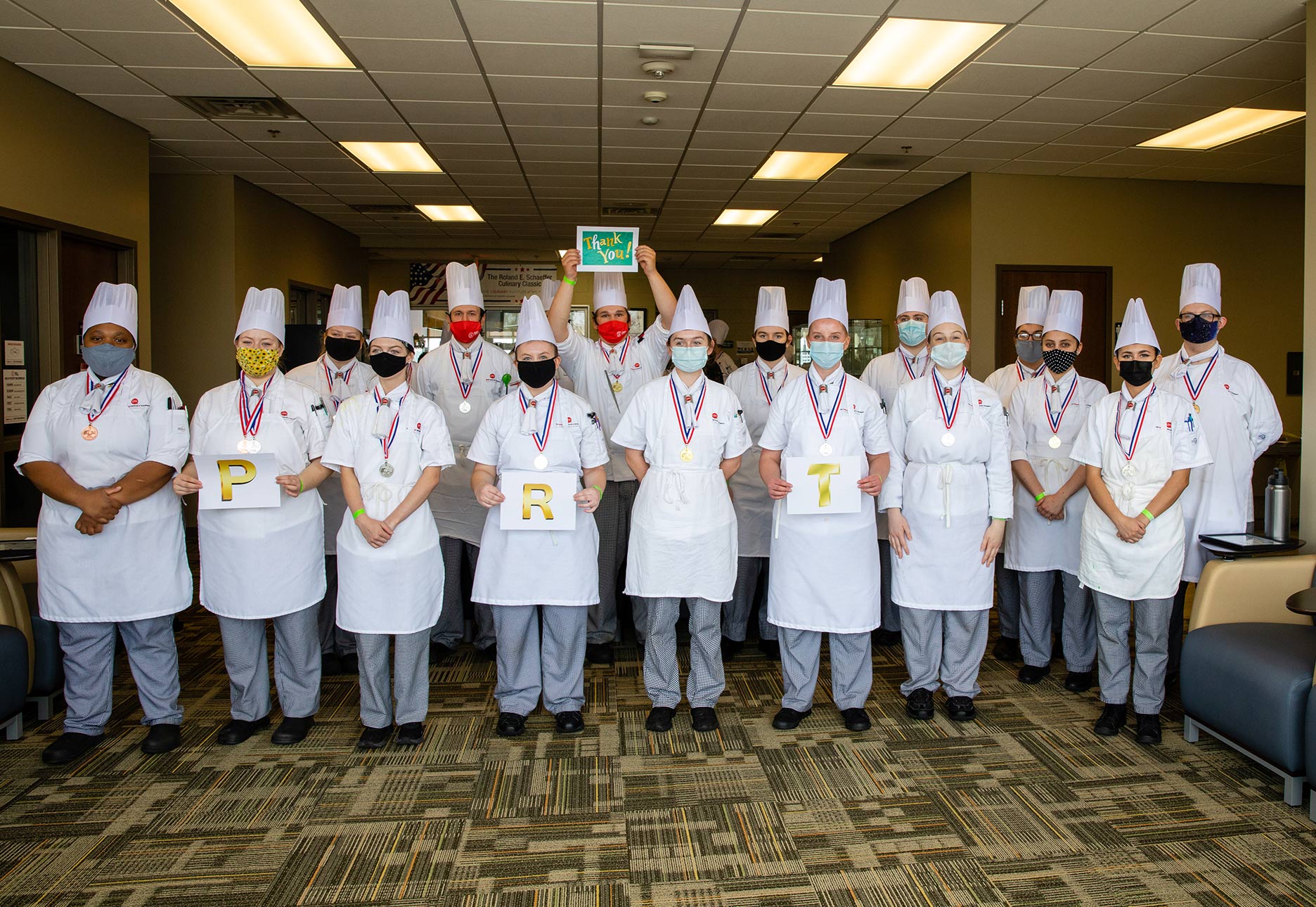 CIM students holding awards.