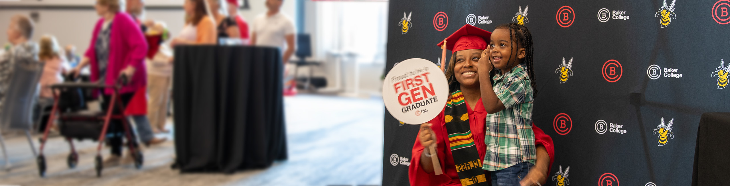 A graduate in a red cap and gown takes a photo with her son in front of a Baker College backdrop. The graduate holds a First Gen sign.