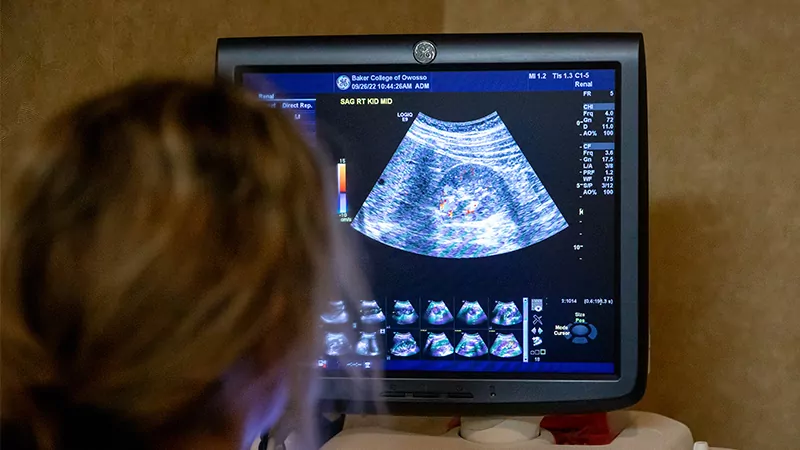 Female student examining with an ultrasound scanner.