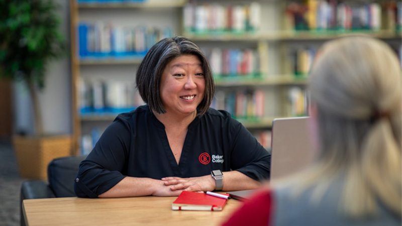 A financial aid counselor talks with a student.