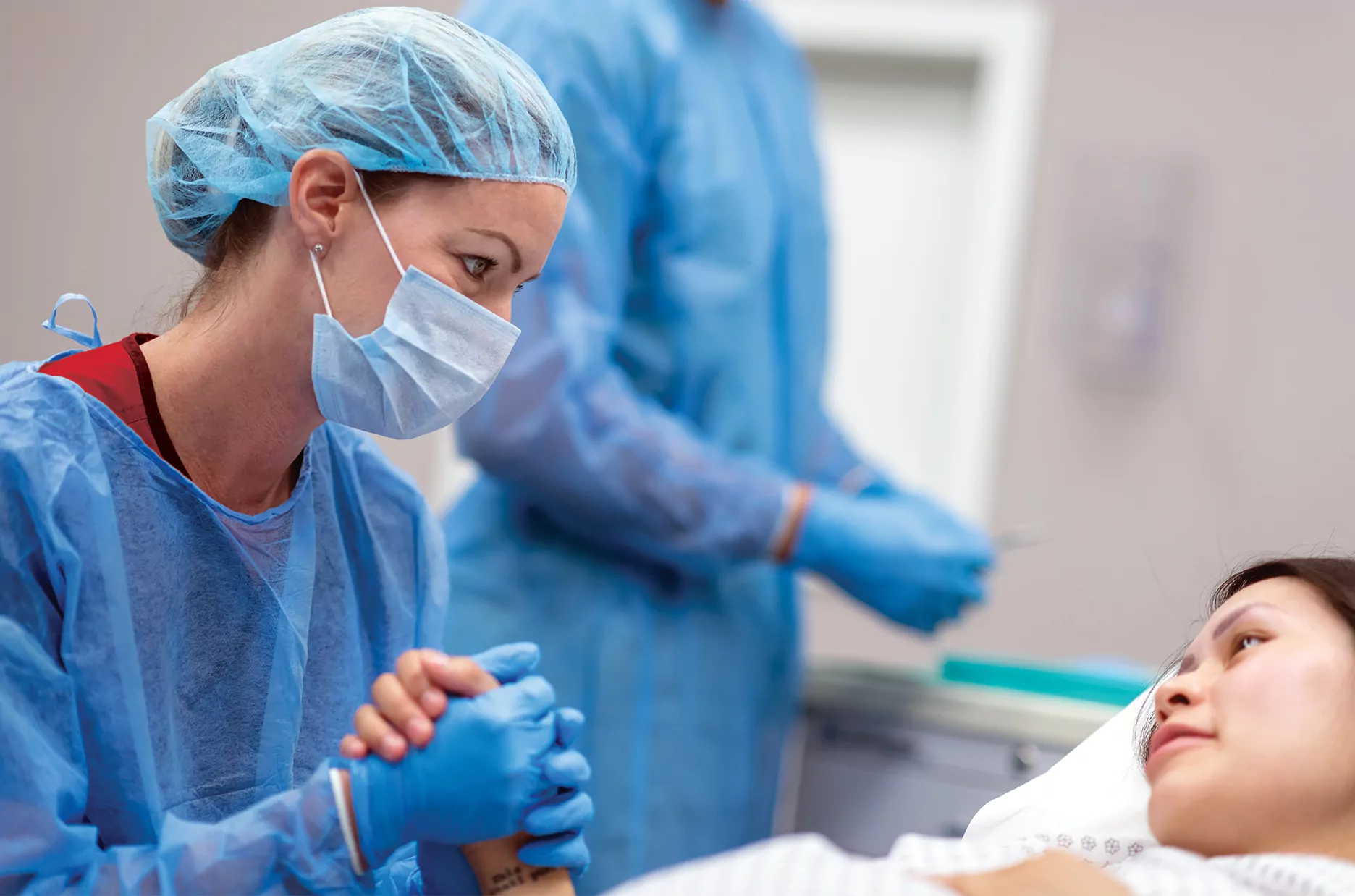 Nurse holding hands with a young patient