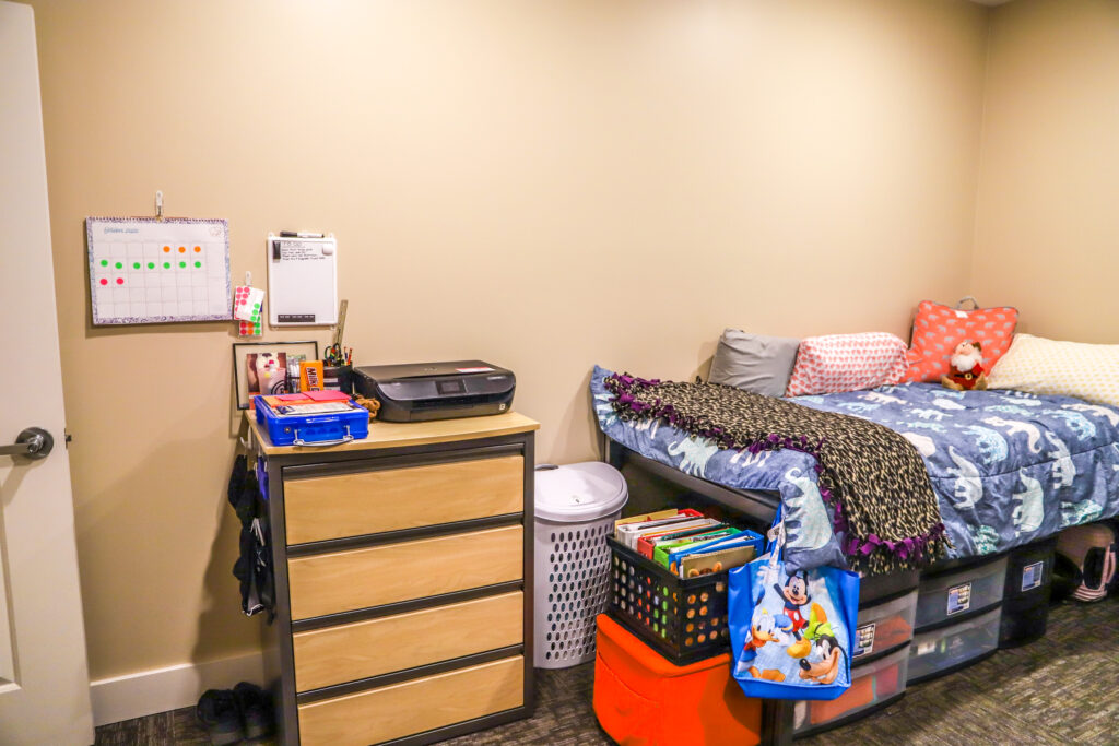 Bedroom with two beds and dressers.