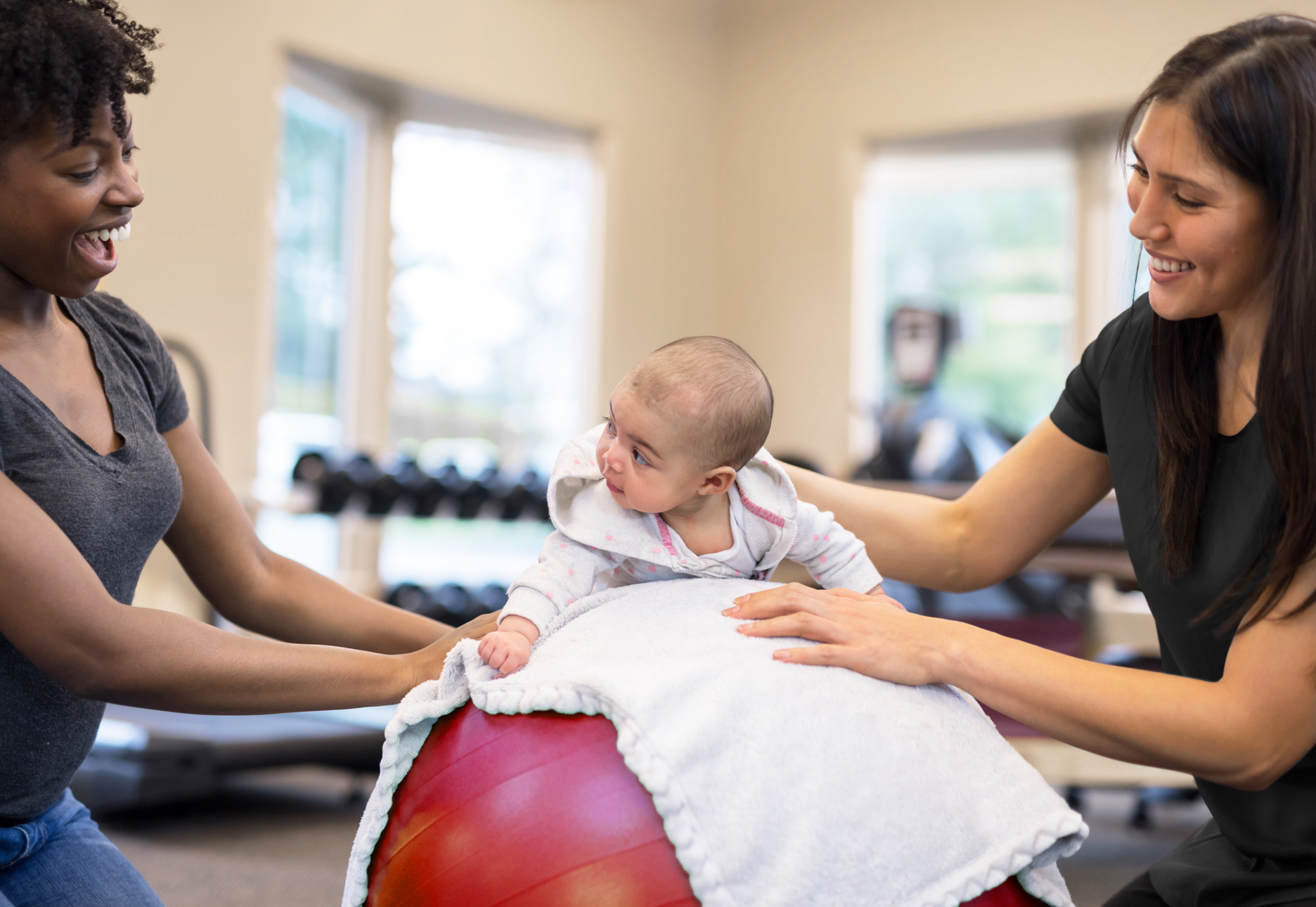 An occupational therapy assistant at work with an infant.