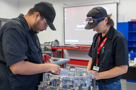 ADI students working on an engine