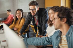 Teacher Giving Lesson to Diverse Multiethnic Group of Female and Male Students in College.