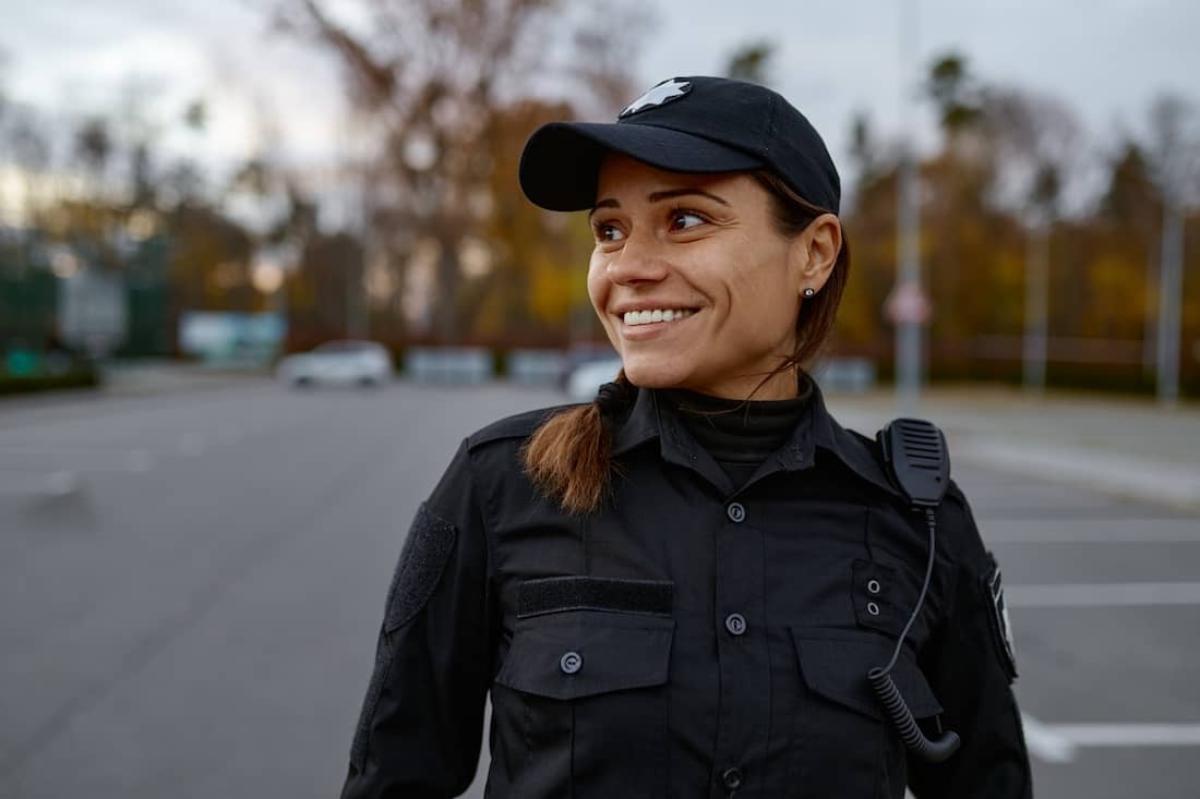 Portrait of smiling police woman on street