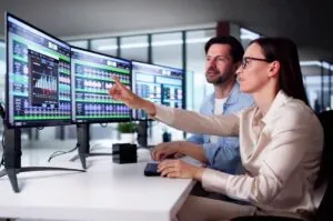 Analyst Employee Working On Spreadsheet Using Desktop Computer