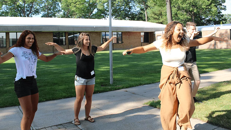 Students perform dance moves at a campus event.