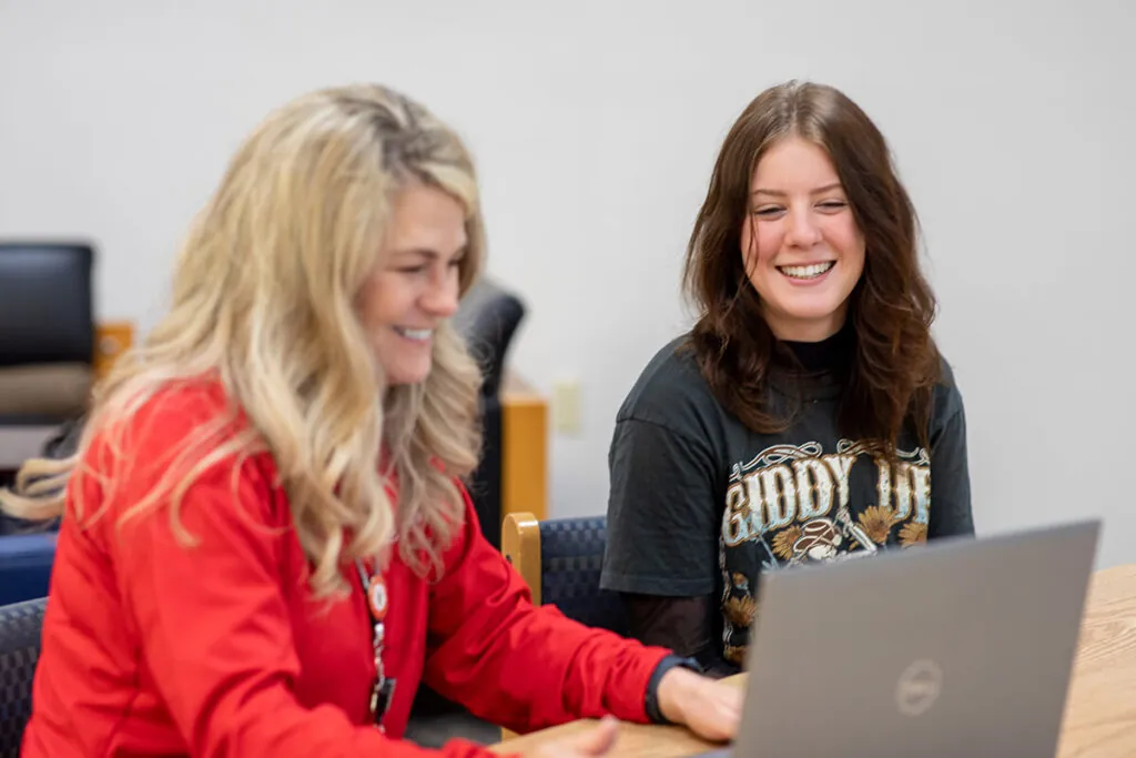 An enrollment advisor helps a student transfer previously earned credits.