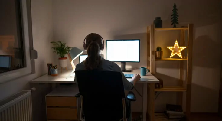 Student with headphones on computer.