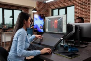 Creative company game developer sitting in production department while developing 3D videogames scenes and environment.