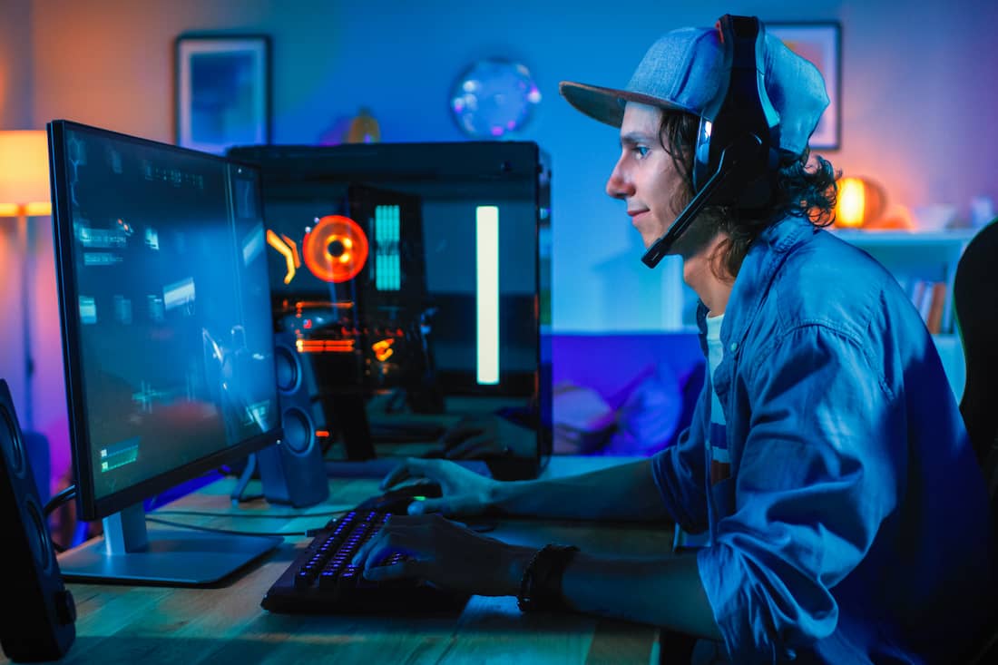 Professional Gamer Playing First-Person Online Video Game on His Personal Computer.