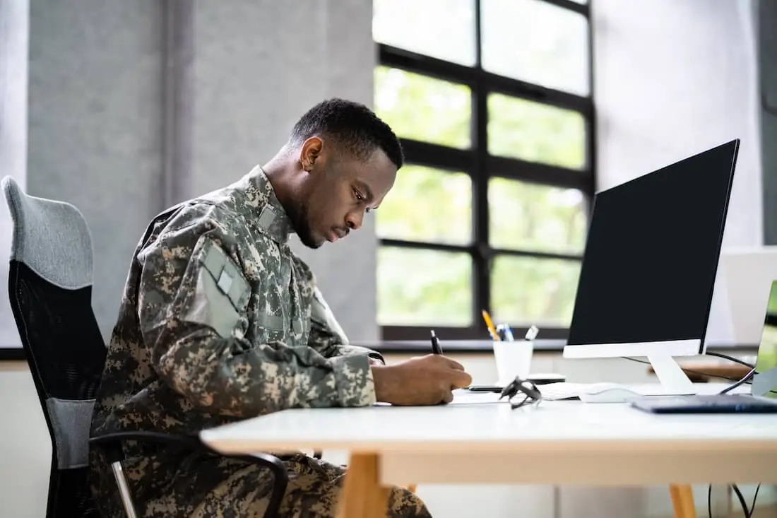 Veteran sitting at a computer attending class.