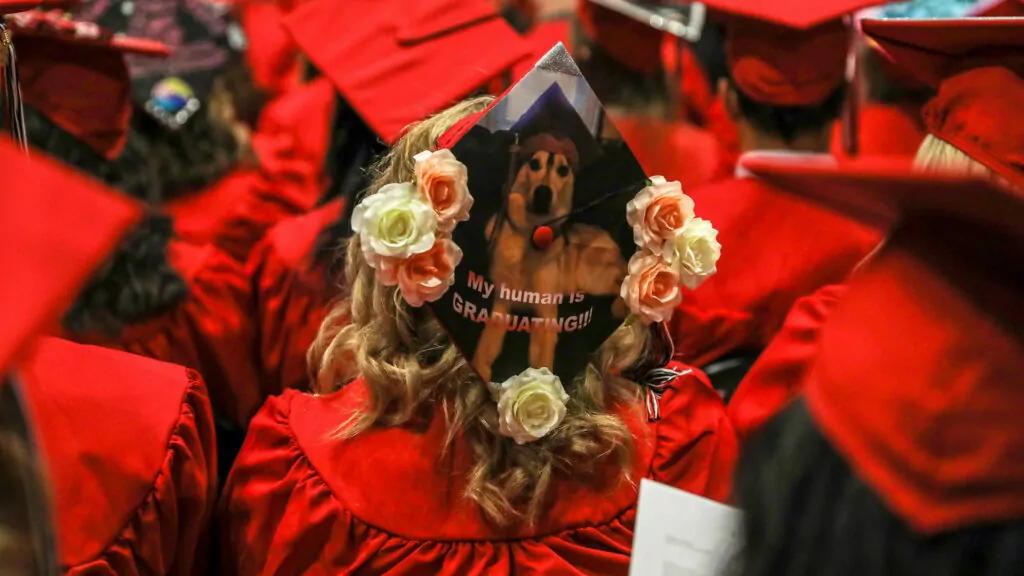 A decorated graduation cap as seen from overhead during the commencement ceremony