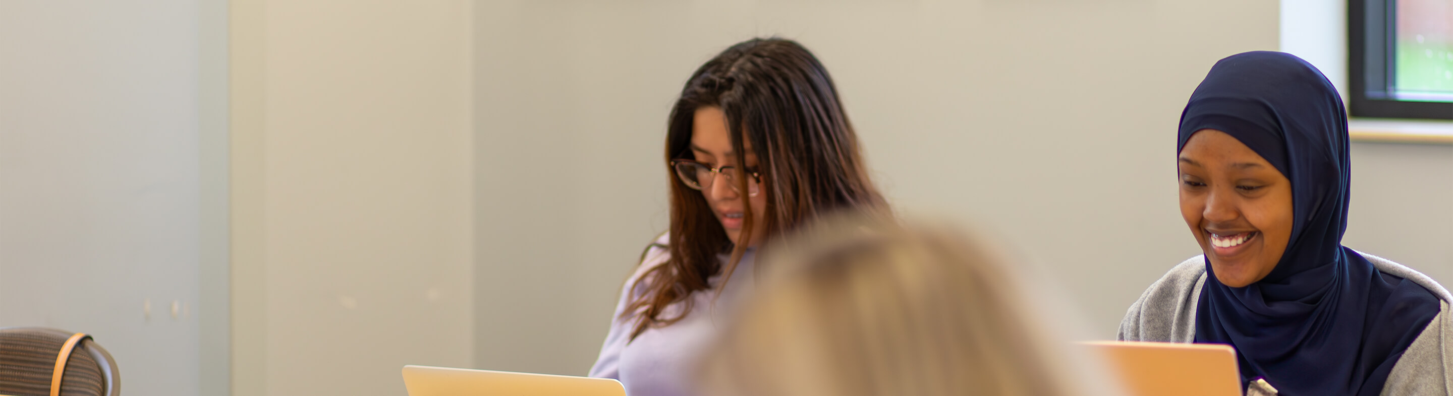 Two students study in a classroom.