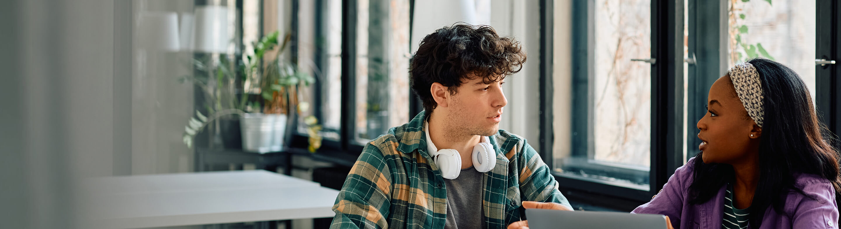 Two students chat while studying on campus.