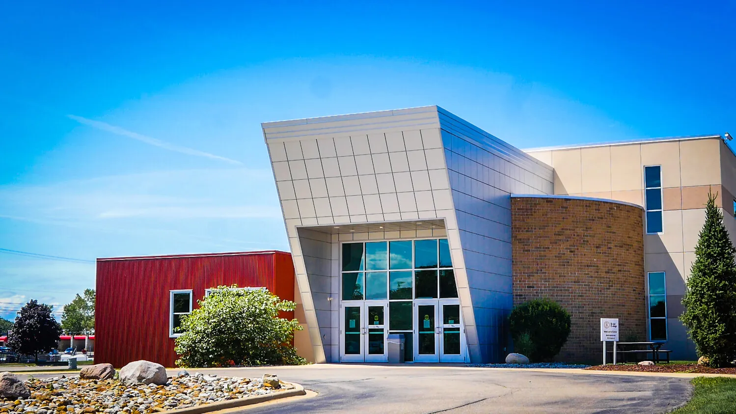 A wide image of the Jackson campus against a vivid blue sky.