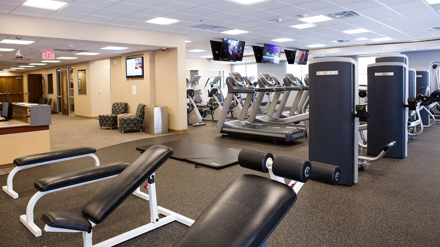 A photo of various workout machines and equipment inside the Muskegon Campus gym.