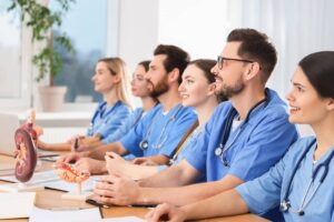 Nursing students in uniforms studying in college.
