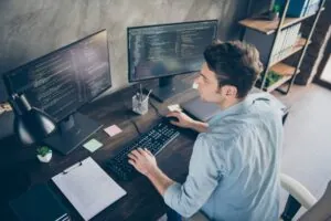 Top above high angle view portrait of male database administrator on computer.