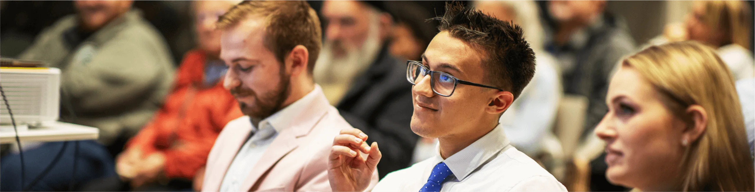 A student listens intently in a crowd.