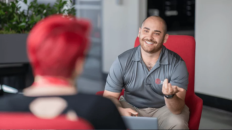 An advisor meets with a student on campus.