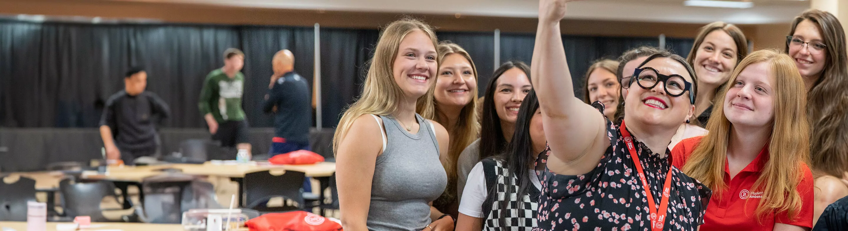 A group of students, and the Dean of Students, gathered to take a photo together. 