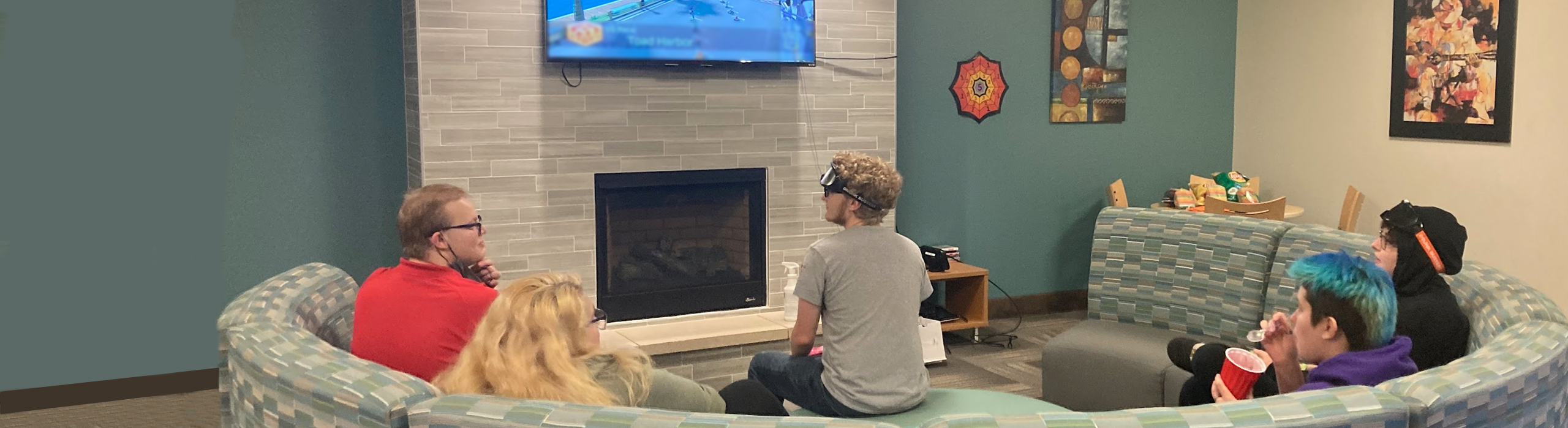 Students in common area watching tv.