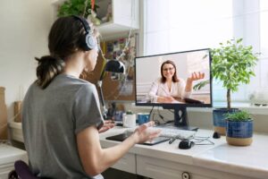 Male student on a video conference with college professor.